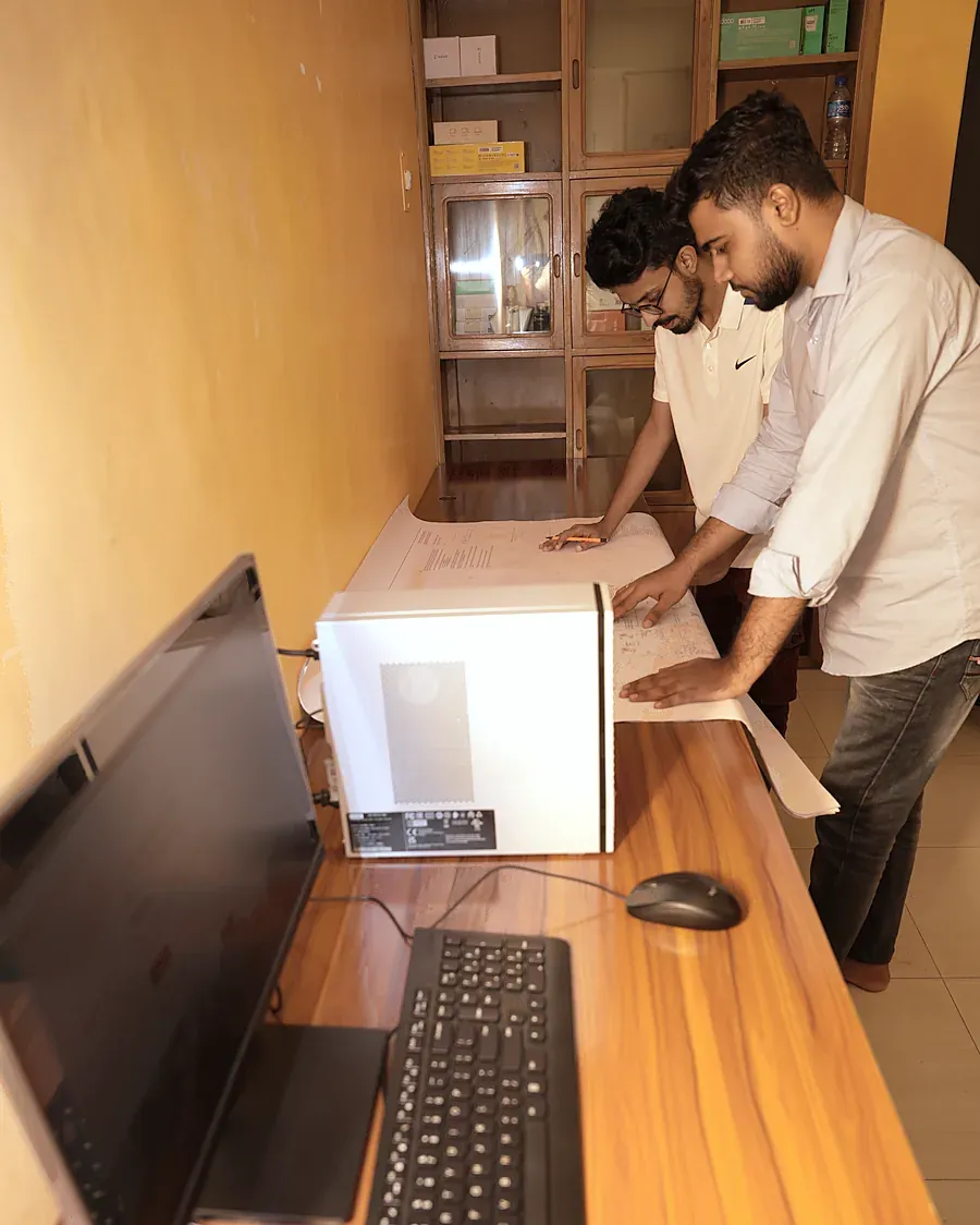 Two colleagues discussing a printout at a desk